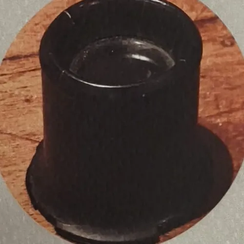 Cesare Mannelli’s black jeweller’s loupe, mounted on ebony, resting on a wooden surface