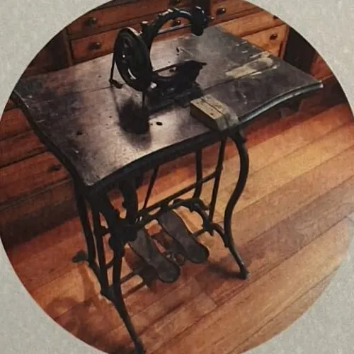 The treadle lathe: a small bench with a dark wooden top, ornate cast-iron legs and two pedals